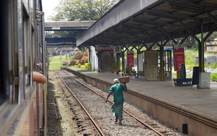 Estación de tren de Sri Lanka con un vendedor en las vías